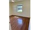 A bright bedroom showcases hardwood floors and a window offering outdoor views at 4511 Ardale St, Sarasota, FL 34232