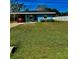 Charming blue single-story home with a well-maintained lawn and covered carport at 4511 Ardale St, Sarasota, FL 34232