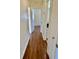 Hallway featuring hardwood floors, leading to various rooms in the house at 4511 Ardale St, Sarasota, FL 34232