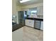 Updated kitchen with granite countertops, stainless steel appliances, and white cabinets at 4511 Ardale St, Sarasota, FL 34232