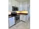 Modern kitchen with stainless steel appliances, granite countertops, and white cabinetry at 4511 Ardale St, Sarasota, FL 34232
