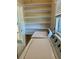 Laundry room with open shelving above a stacked washer and dryer at 4511 Ardale St, Sarasota, FL 34232