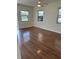 Spacious living room with wood floors, ceiling fan, and bright natural light at 4511 Ardale St, Sarasota, FL 34232