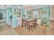 Charming dining room featuring built-in cabinets, aqua walls, and a wooden table set for four, creating a cozy atmosphere at 4711 15Th Street E Ct, Ellenton, FL 34222