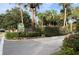 A welcoming 'Village Gardens' sign amidst lush greenery, reflecting the community's serene atmosphere at 4843 Village Gardens Dr # 176, Sarasota, FL 34234