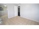 Cozy bedroom with tile flooring, mirrored closet, and a glimpse into the adjacent room at 5009 21St W St, Bradenton, FL 34207