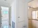 Hallway view showcasing access to a full bathroom and another room with a ceiling fan at 521 Fairview Nw Ave, Port Charlotte, FL 33952