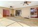 Large covered patio featuring textured concrete flooring, ceiling fans, and sliding glass doors leading to the pool at 521 Fairview Nw Ave, Port Charlotte, FL 33952