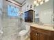 Well-appointed bathroom featuring modern fixtures, a glass-enclosed shower, and a vanity with dark-stained cabinets at 5242 Highbury Cir, Sarasota, FL 34238