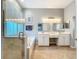 Elegant bathroom with double vanities, a soaking tub, and a separate glass-enclosed shower at 5242 Highbury Cir, Sarasota, FL 34238