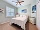 Cozy bedroom with a ceiling fan and a sunlit window offers a relaxing atmosphere at 5242 Highbury Cir, Sarasota, FL 34238