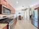 Well-equipped kitchen with stainless steel appliances and granite counters, seamlessly connecting to dining area at 5242 Highbury Cir, Sarasota, FL 34238