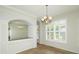 Dining room with tile flooring, chandelier, and archway to the kitchen at 5453 New Covington Dr, Sarasota, FL 34233