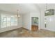 Living room with tile flooring, natural light, and view of the front door at 5453 New Covington Dr, Sarasota, FL 34233