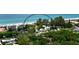 This aerial view shows the beach and resort property from above at 5581 Gulf Of Mexico Dr, Longboat Key, FL 34228