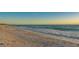 Beautiful view of the coastline with waves gently crashing on the sandy beach at 5581 Gulf Of Mexico Dr, Longboat Key, FL 34228