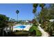 The pool is surrounded by lush landscaping and palm trees at 5581 Gulf Of Mexico Dr, Longboat Key, FL 34228