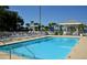 Sparkling pool area featuring chairs, tables, and shady gazebos for relaxing at 5581 Gulf Of Mexico Dr, Longboat Key, FL 34228