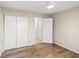Bedroom featuring wood floors, a closet, and ceiling fan at 5907 Garden Ln # H26, Bradenton, FL 34207