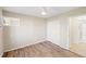 Bright bedroom with ceiling fan, a light-colored wall, and a view of the bathroom at 5907 Garden Ln # H26, Bradenton, FL 34207