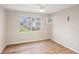Bedroom featuring wood floors, window AC, and a large window at 5907 Garden Ln # H26, Bradenton, FL 34207