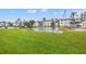 Relaxing community green with picnic benches, shuffle board, and condo buildings at 5907 Garden Ln # H26, Bradenton, FL 34207