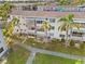 Bright condo exterior featuring screened in lanais and lush tropical landscaping at 5907 Garden Ln # H26, Bradenton, FL 34207