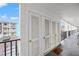 Hallway featuring white storage lockers and a welcoming doormat with an outdoor view at 5907 Garden Ln # H26, Bradenton, FL 34207