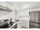 Updated kitchen featuring stainless steel appliances and modern lighting at 5907 Garden Ln # H26, Bradenton, FL 34207