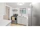 Bright kitchen with stainless steel appliances, white cabinetry, quartz countertops and tile flooring at 5907 Garden Ln # H26, Bradenton, FL 34207