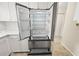 Stainless steel kitchen refrigerator with white cabinets and tile flooring at 5907 Garden Ln # H26, Bradenton, FL 34207
