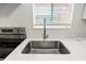 Close up of stainless steel kitchen sink, quartz countertops, and stainless steel faucet at 5907 Garden Ln # H26, Bradenton, FL 34207