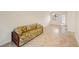 Living room showing the tile floor and rattan sofa at 5907 Garden Ln # H26, Bradenton, FL 34207
