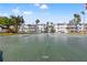 Green shuffleboard court surrounded by palm trees and condo buildings at 5907 Garden Ln # H26, Bradenton, FL 34207