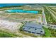 Stunning aerial view of a luxurious home near a vibrant community and sparkling blue lagoon at 6013 White Mangrove Ln, Bradenton, FL 34210