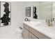 Modern powder room featuring a vanity with quartz countertop, stylish mirror, and sleek decor at 6013 White Mangrove Ln, Bradenton, FL 34210