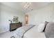 A calming bedroom displays a modern dresser, pendant light, and comfortable bed at 6013 White Mangrove Ln, Bradenton, FL 34210
