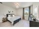 Bright bedroom featuring a comfortable bed, modern decor, and natural light from the window at 6013 White Mangrove Ln, Bradenton, FL 34210
