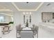 Bright dining room features stylish lighting, wine rack, and sleek table setting for elegant entertaining at 6013 White Mangrove Ln, Bradenton, FL 34210