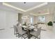 Sophisticated dining room offers recessed lighting, modern table setting, and views into the living area at 6013 White Mangrove Ln, Bradenton, FL 34210