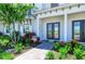 Inviting entryway with a stone walkway, a beautifully landscaped garden and a covered front porch at 6013 White Mangrove Ln, Bradenton, FL 34210