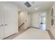 Bright hallway with white walls, trim and doors, and a staircase and recessed lighting at 6013 White Mangrove Ln, Bradenton, FL 34210