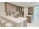Modern kitchen featuring stainless steel appliances, quartz countertops, and a functional center island at 6013 White Mangrove Ln, Bradenton, FL 34210