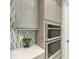 Updated kitchen with sleek stainless steel appliances and hexagon tile backsplash at 6013 White Mangrove Ln, Bradenton, FL 34210