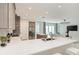 Spacious kitchen featuring quartz countertops, stainless steel appliances, and open layout to living area at 6013 White Mangrove Ln, Bradenton, FL 34210