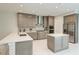 Contemporary kitchen featuring stainless steel appliances, quartz countertops, and custom cabinetry at 6013 White Mangrove Ln, Bradenton, FL 34210