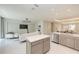 Open floorplan featuring a kitchen island with modern appliances and neutral color palette at 6013 White Mangrove Ln, Bradenton, FL 34210