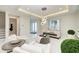 Elegant living room with modern chandelier, sleek decor, and access to the entryway at 6013 White Mangrove Ln, Bradenton, FL 34210