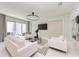 This living room features neutral tones, modern lighting, and an adjacent patio at 6013 White Mangrove Ln, Bradenton, FL 34210