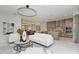 Bright living space open to the kitchen features modern lighting, neutral tones, and seating at 6013 White Mangrove Ln, Bradenton, FL 34210